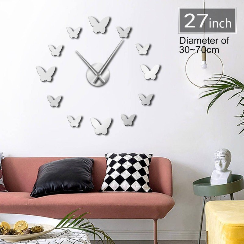 ساعة حائط لزقات لون فضي شكل فراشة