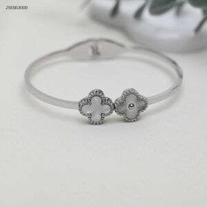 سوار عريض مزين بورقتي برسيم لون فضي وابيض