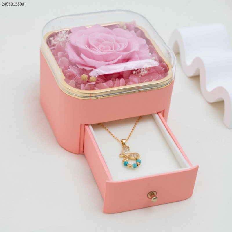 صندوق هدايا للمجوهرات زهري وذهبي مع ورد زهري